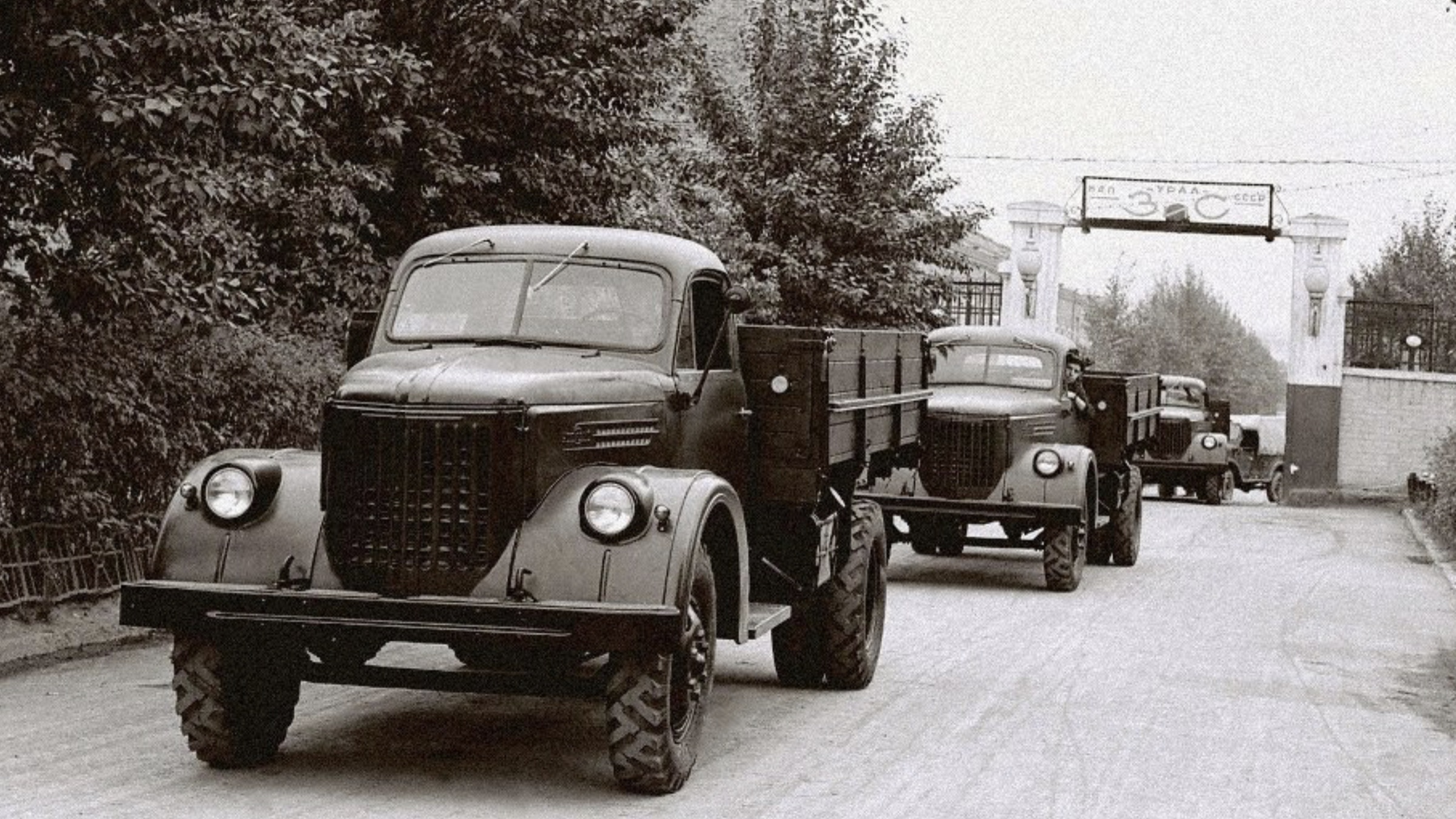 Convoy of early trucks leaving the automobile plant